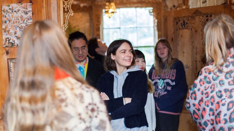 People looking around the living room of 575 Wandsworth Road
